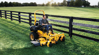 man riding commercial lawn mower